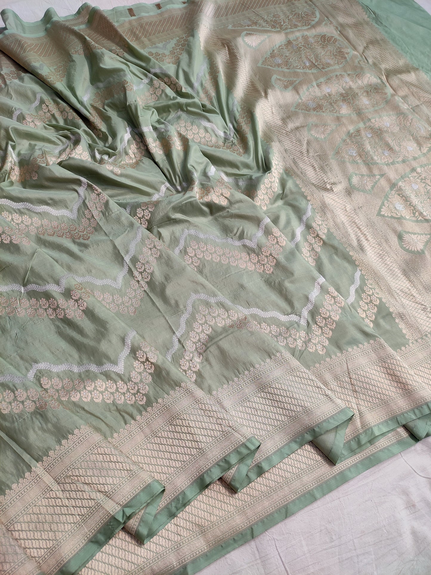 Banarasi Pure Katan Silk Pista Green Base Sarees Enhanced with Distinctive Sona Rupa Zig Zag Detailing